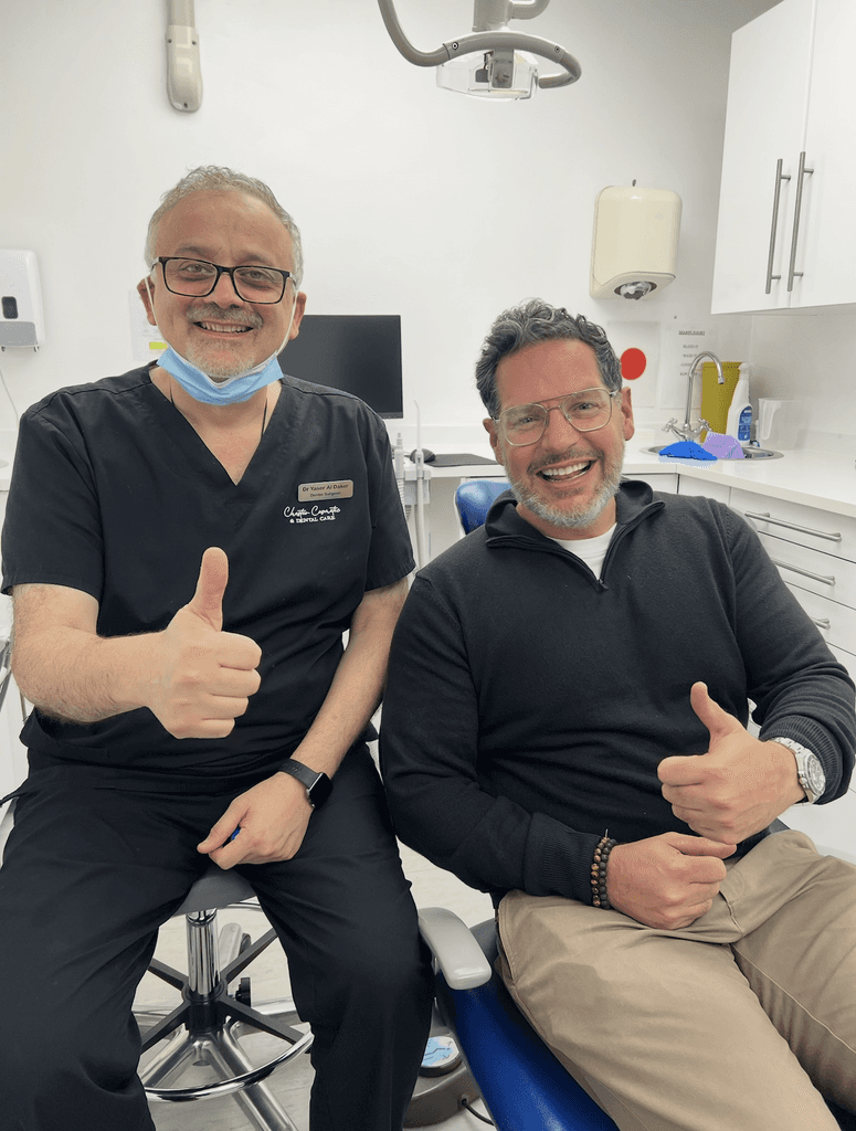 a dentist and his nurse wokring on a patients oral health