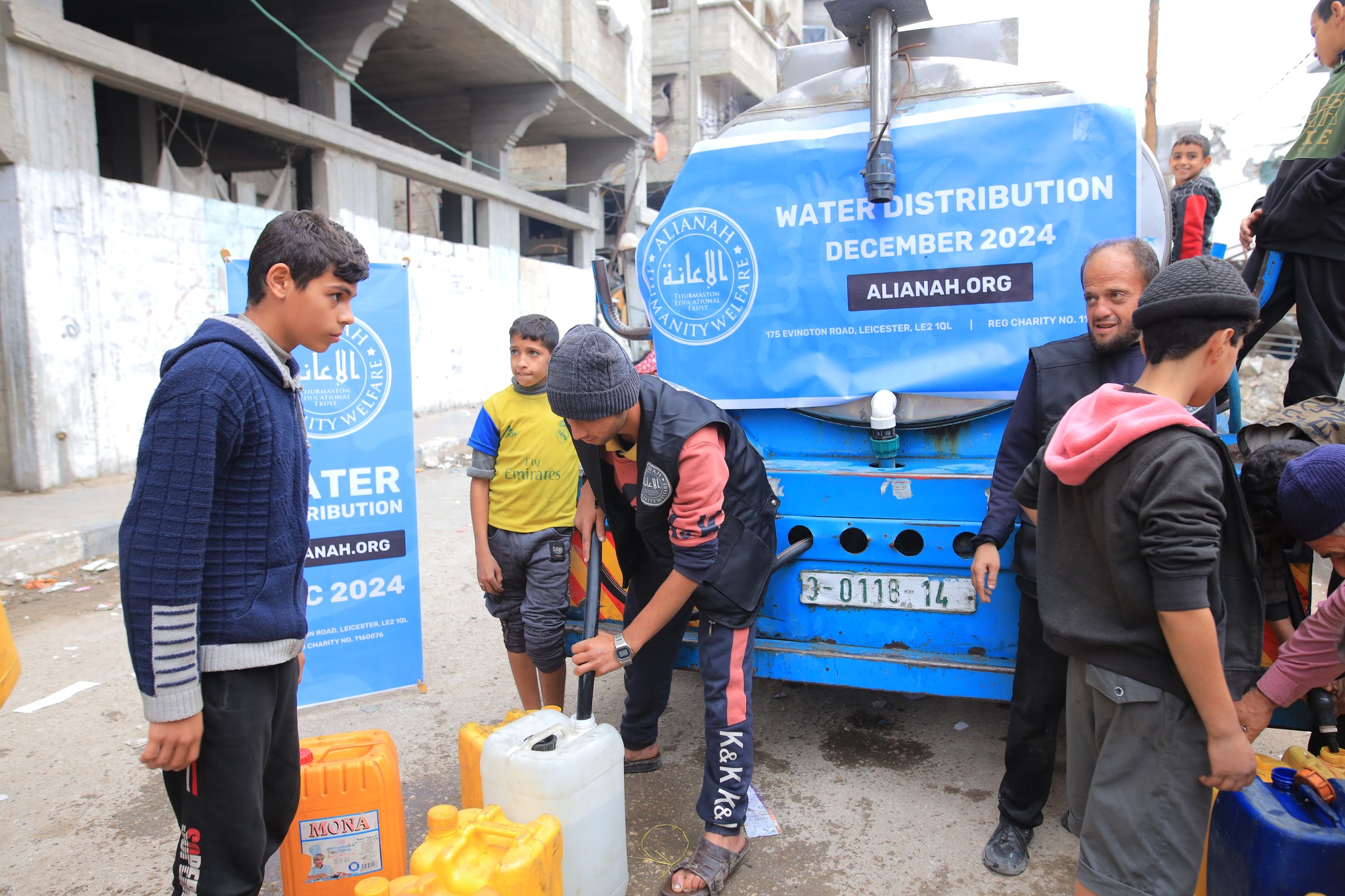 A couple of kids that are sitting in the grass