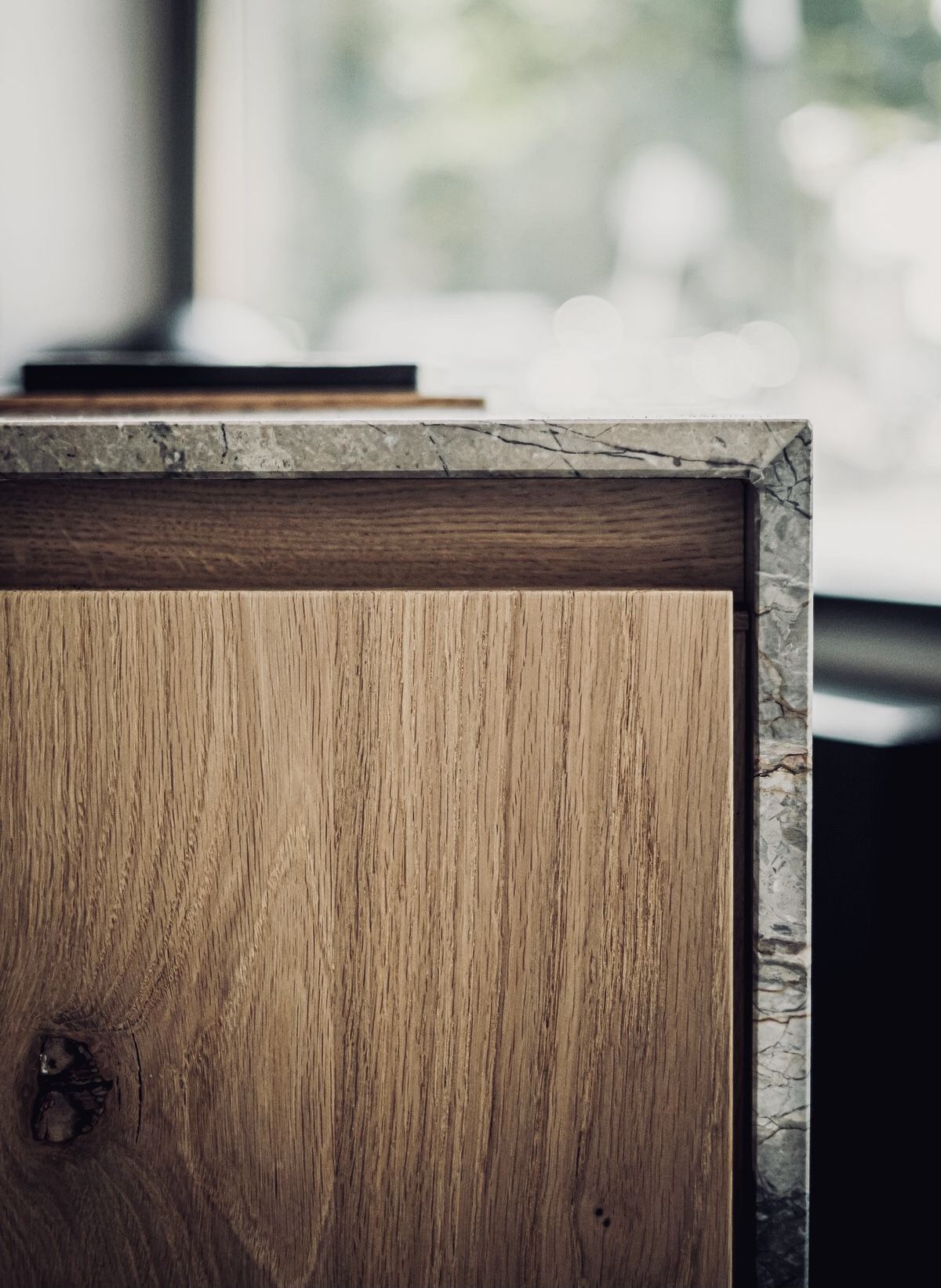 three people sitting in front of table laughing together