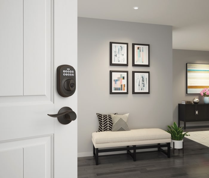 Keypad Deadbolt with Plymouth trim paired with an Accent lever in Aged Bronze.
