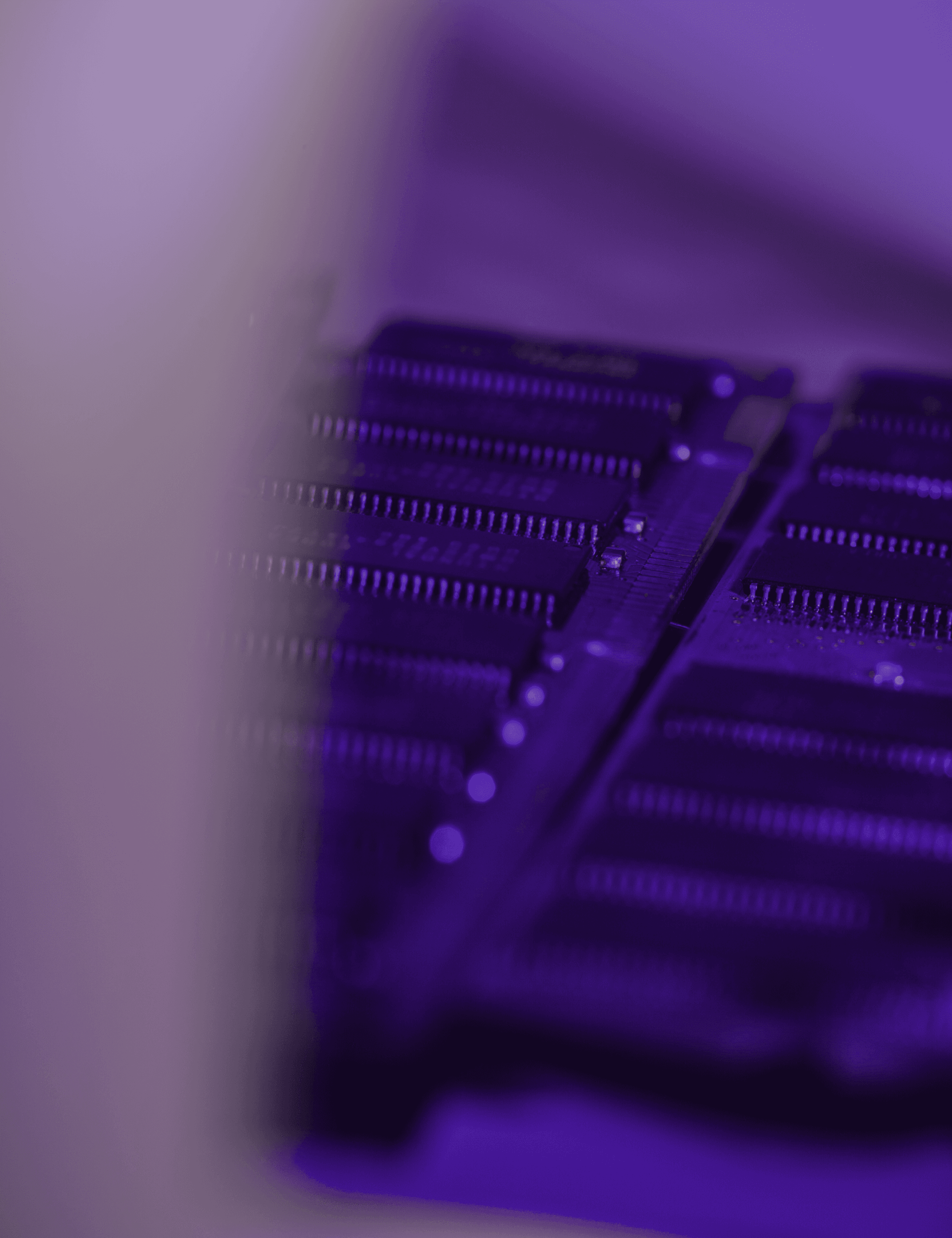 Close-up of a circuit board under purple light