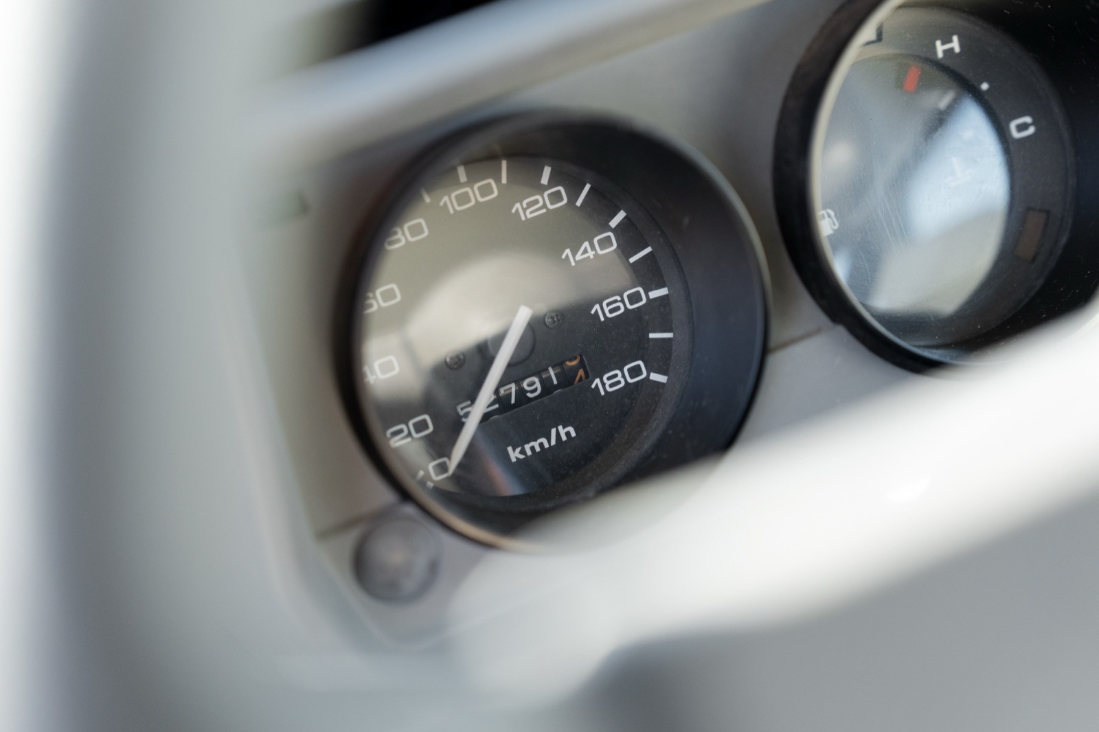 Close-up of a vehicle dashboard gauge, showing speed and other measurements.