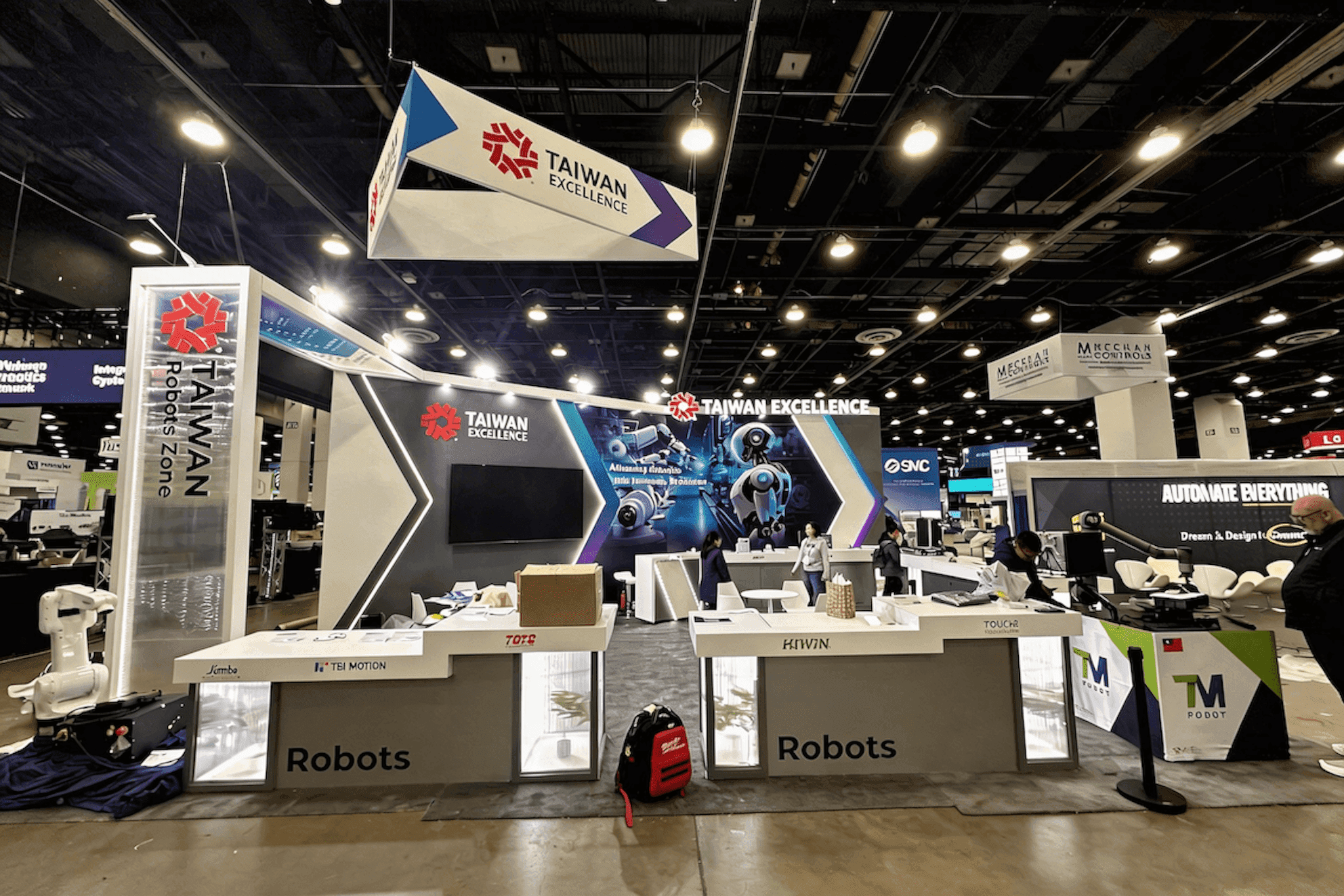 Taiwan Excellence Automate 2025 20x30 industrial automation booth with robotics demo counters and open front visitor flow