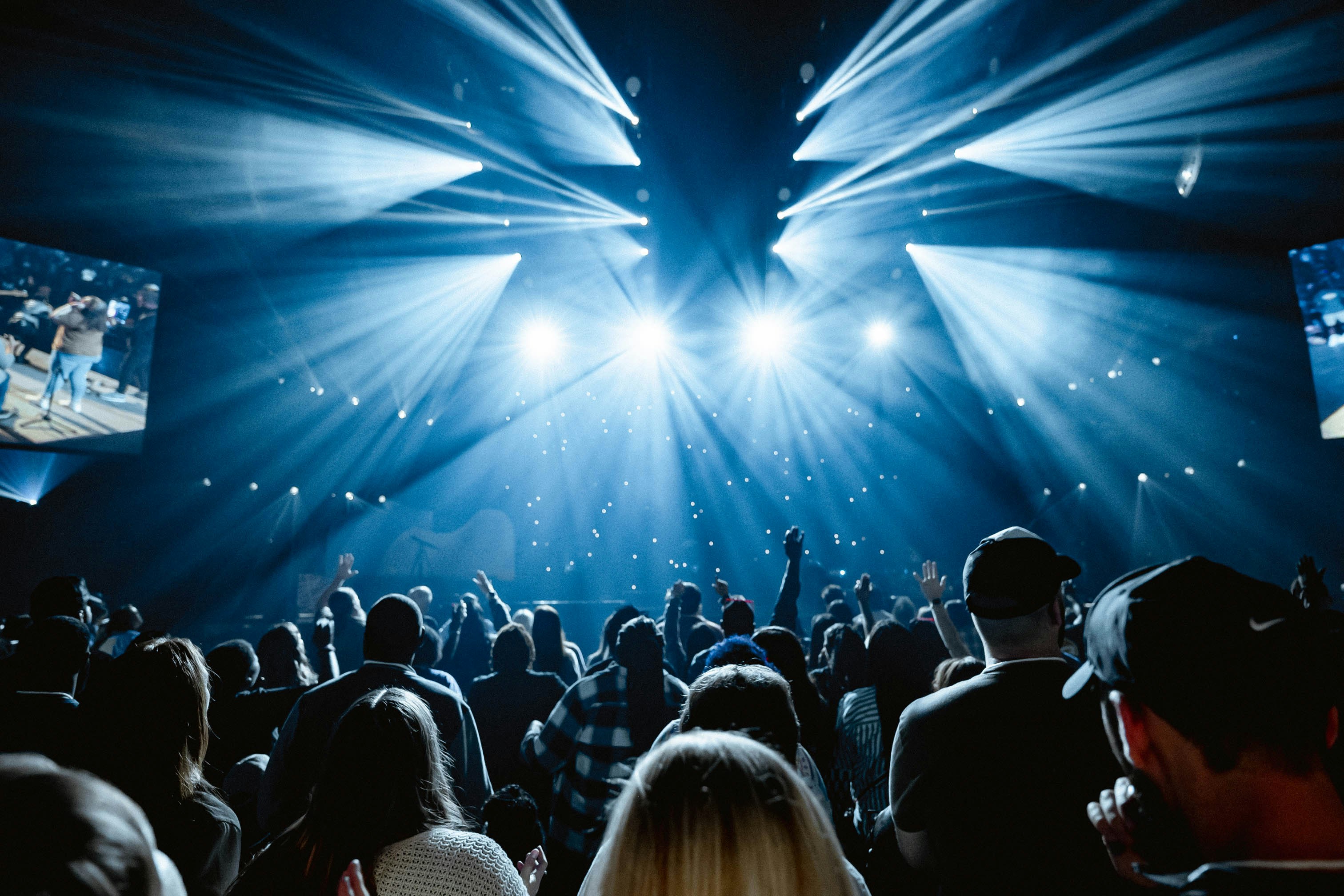 A large crowd of people in a dark room