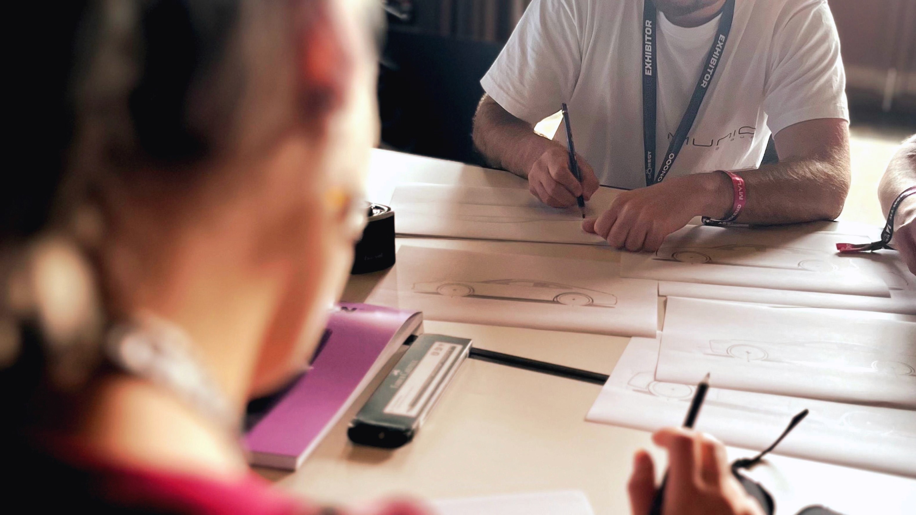 Detail view of a team member sketching during the design process