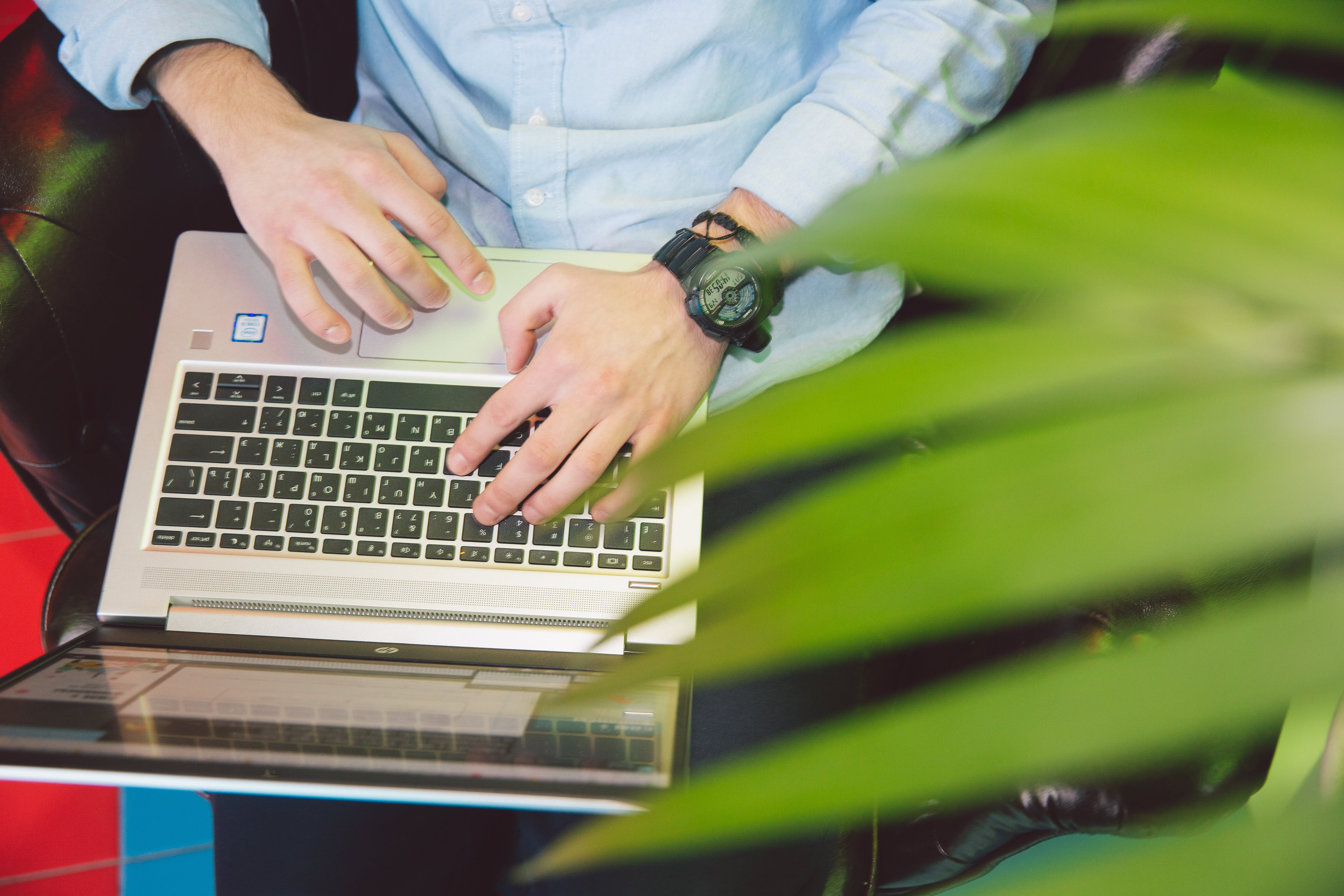 Person in white shirt using laptop writing cold emails