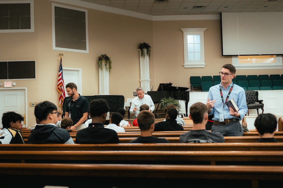 Teachers and pastors leading small groups after a high school chapel