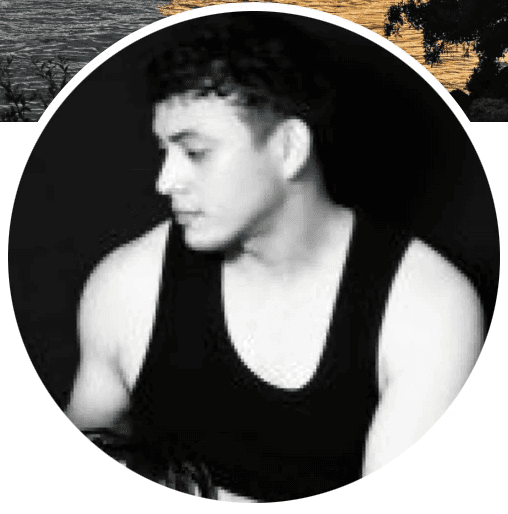 A person on a white shirt and black coat standing at the window indoor of the office