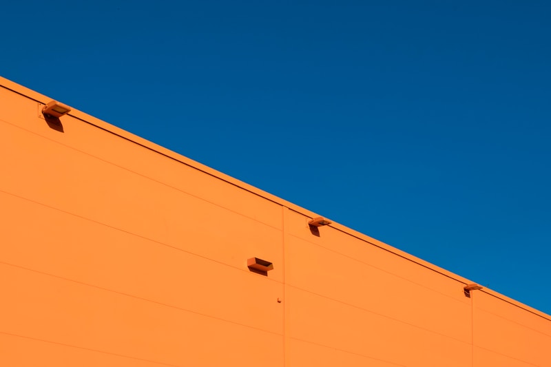 Blue and orange facade panels in bright sun