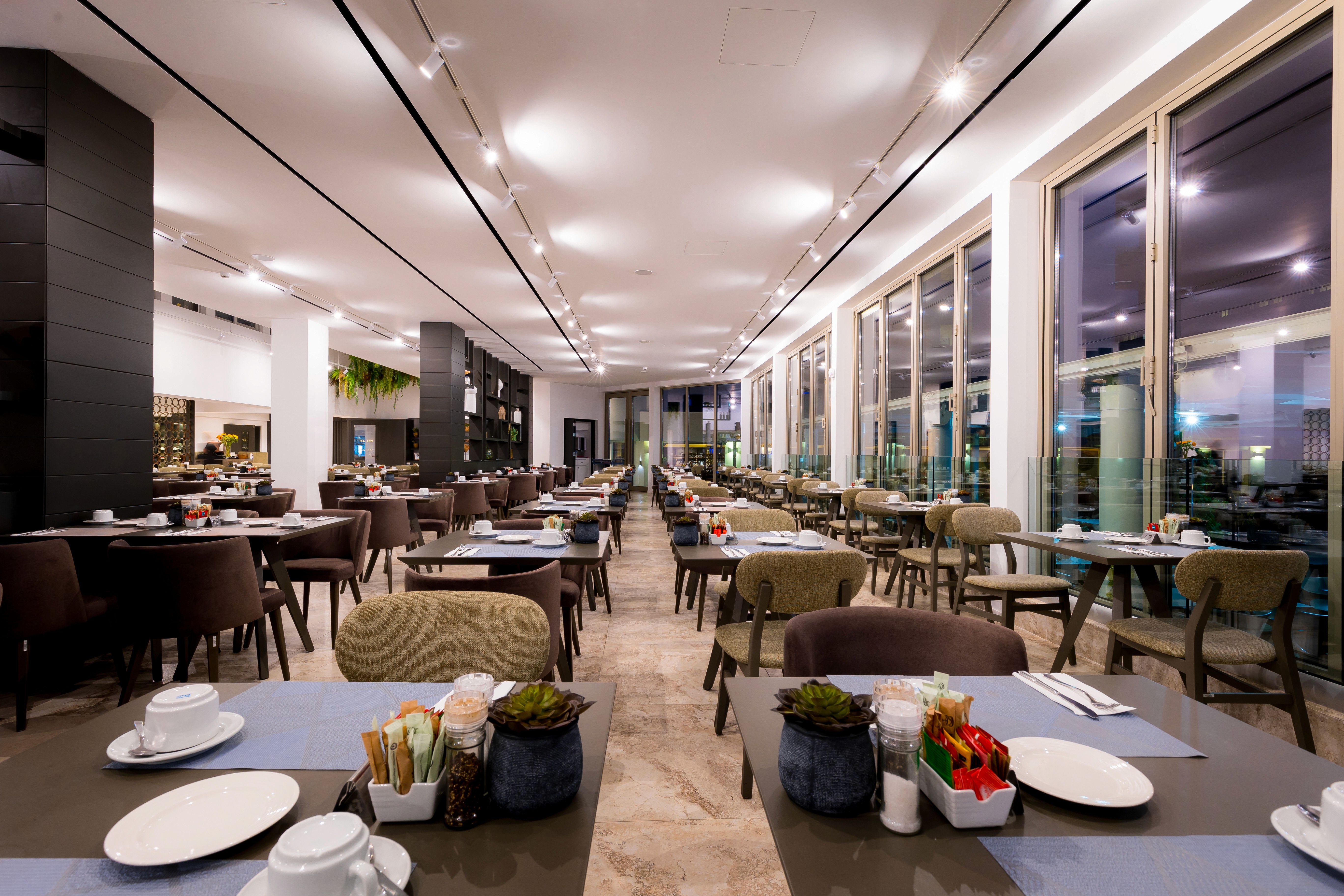 Geometric black timber shelving used as an acoustic filter in a large social space by topos design studio