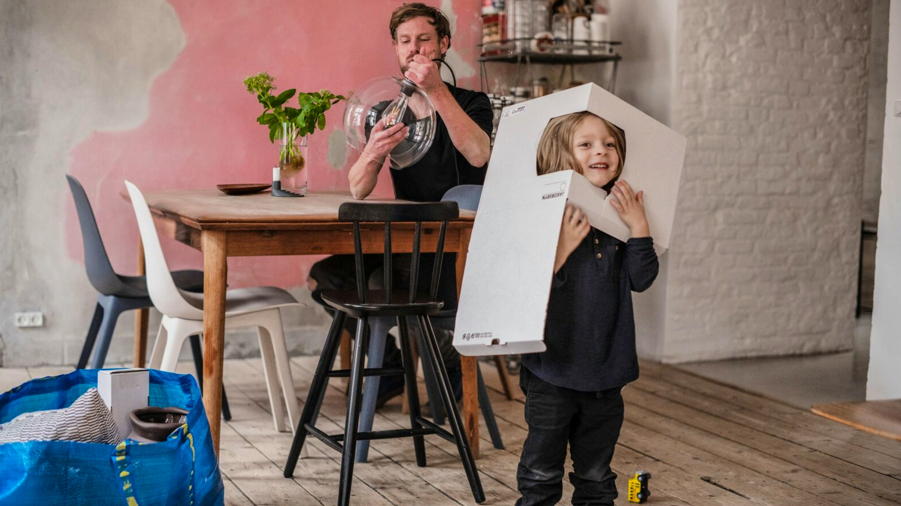 IKEA — father assembling furniture while a young child playfully wears a flat-pack box as a hat in a cosy home — Soda Studio case study