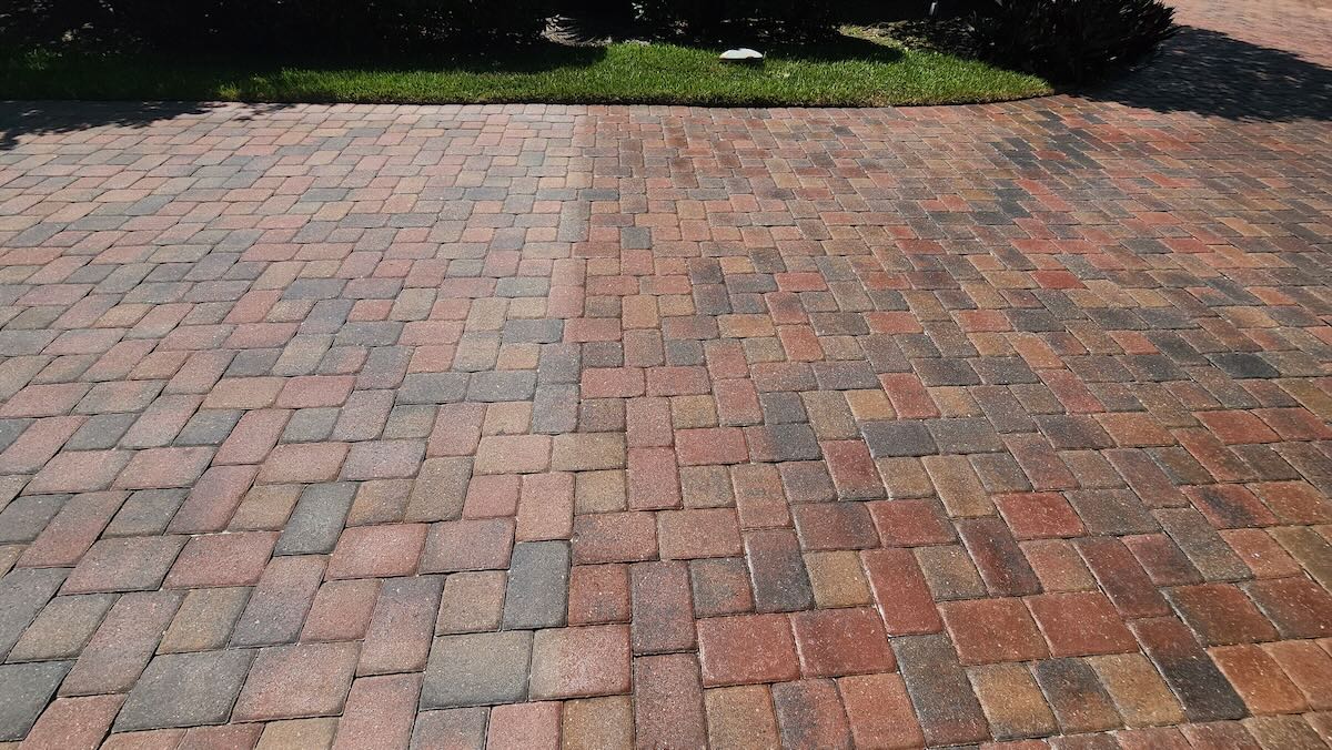 Restored red paver surface with renewed color after cleaning and sealing