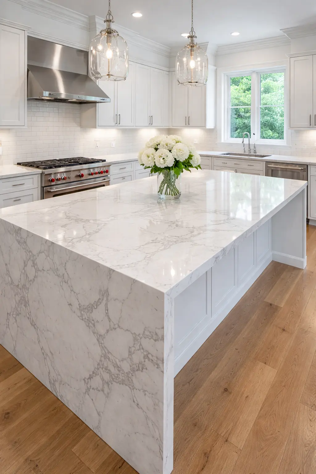 Post-construction kitchen cleaning results featuring a polished marble waterfall island, stainless steel appliances, and dust-free pendant lighting.