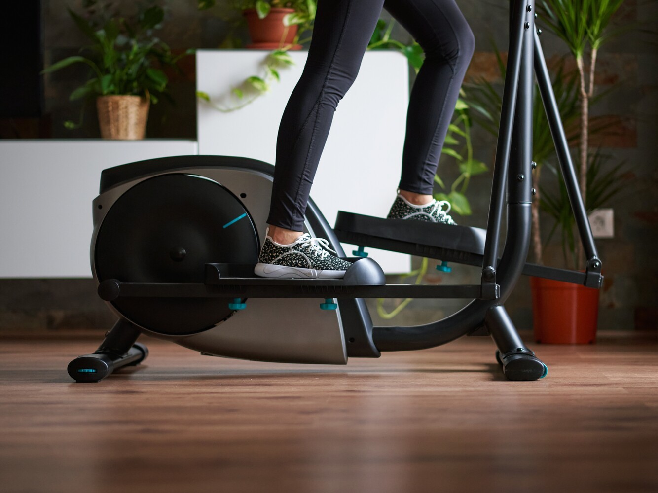 woman using an elliptical at home instead of a bicycle for weight loss