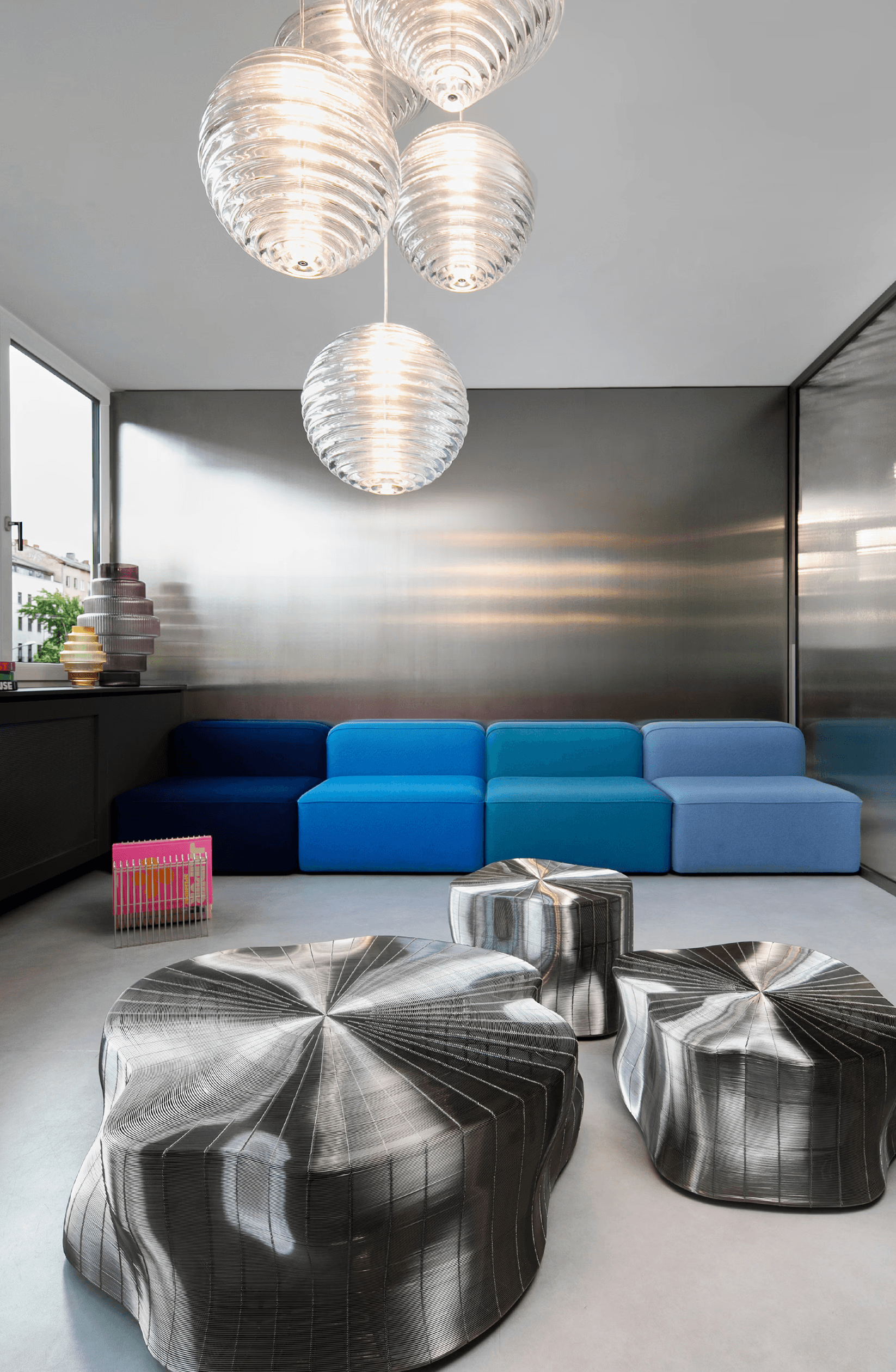 Close-up of hands holding a small glass bottle with a liquid skincare product, against a soft, blurred background