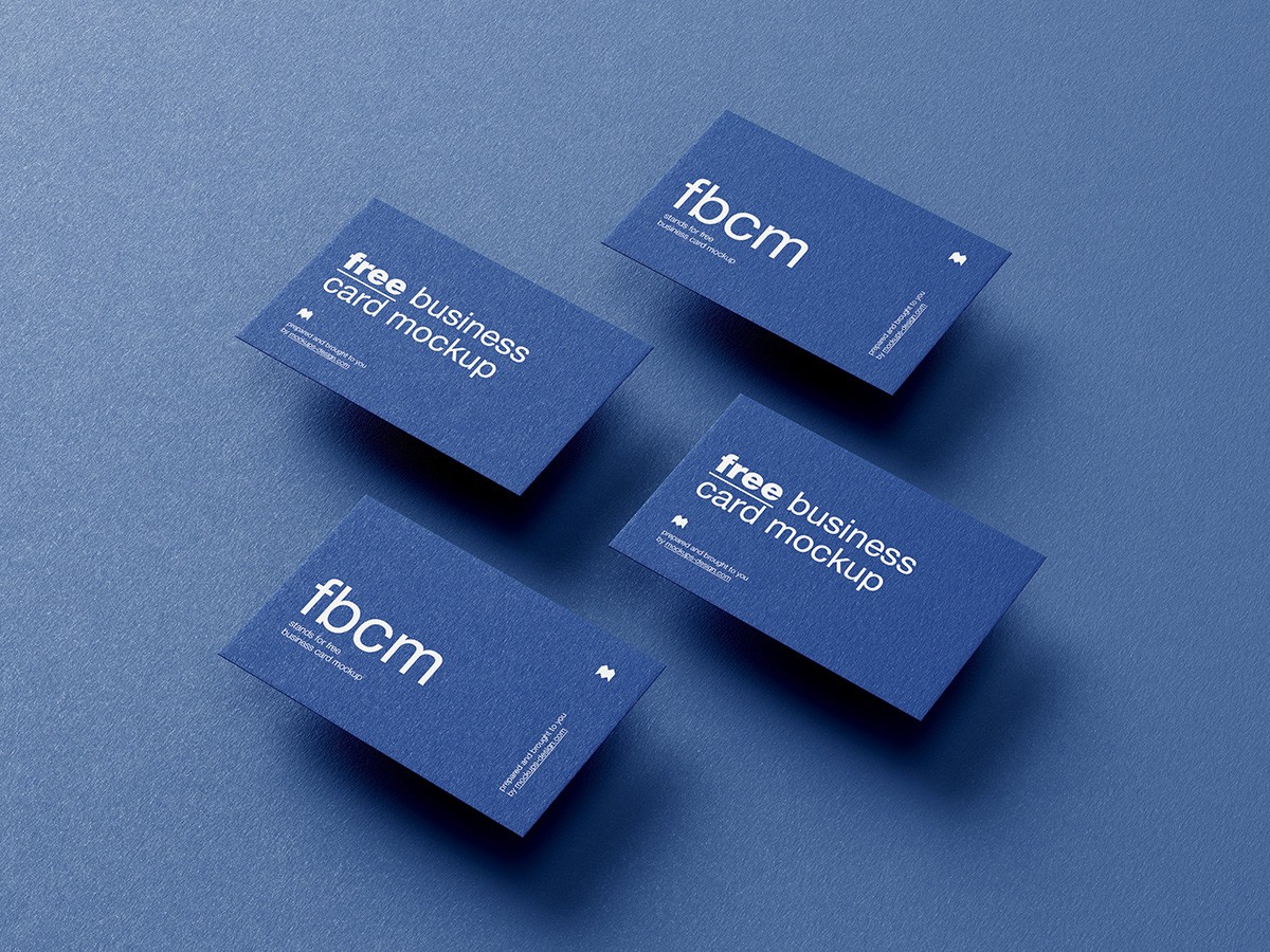 Four blue business cards with white text, arranged diagonally on a textured blue background. Light shadows add depth, creating a professional, modern tone.