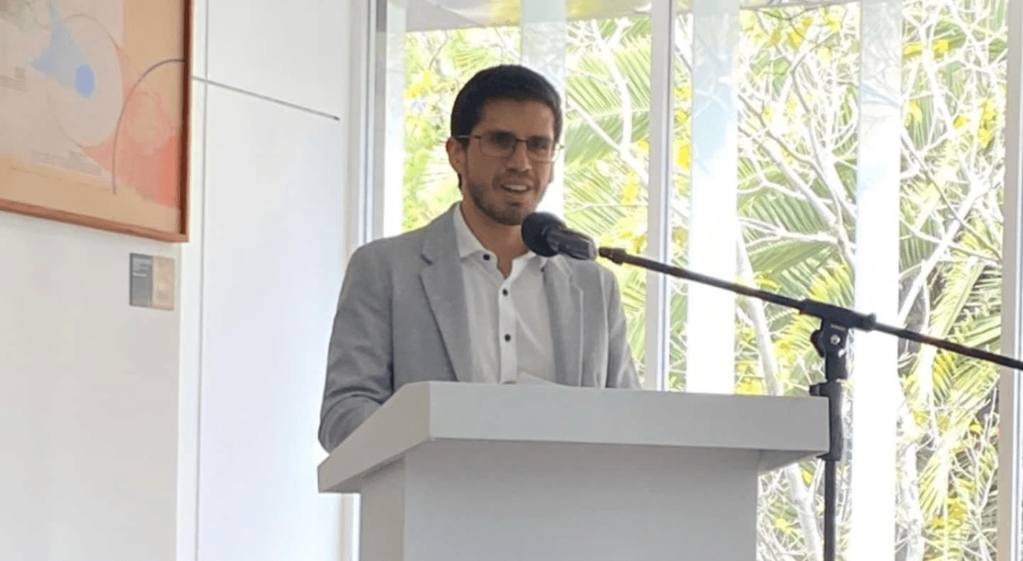 a man sitting in front of a laptop computer