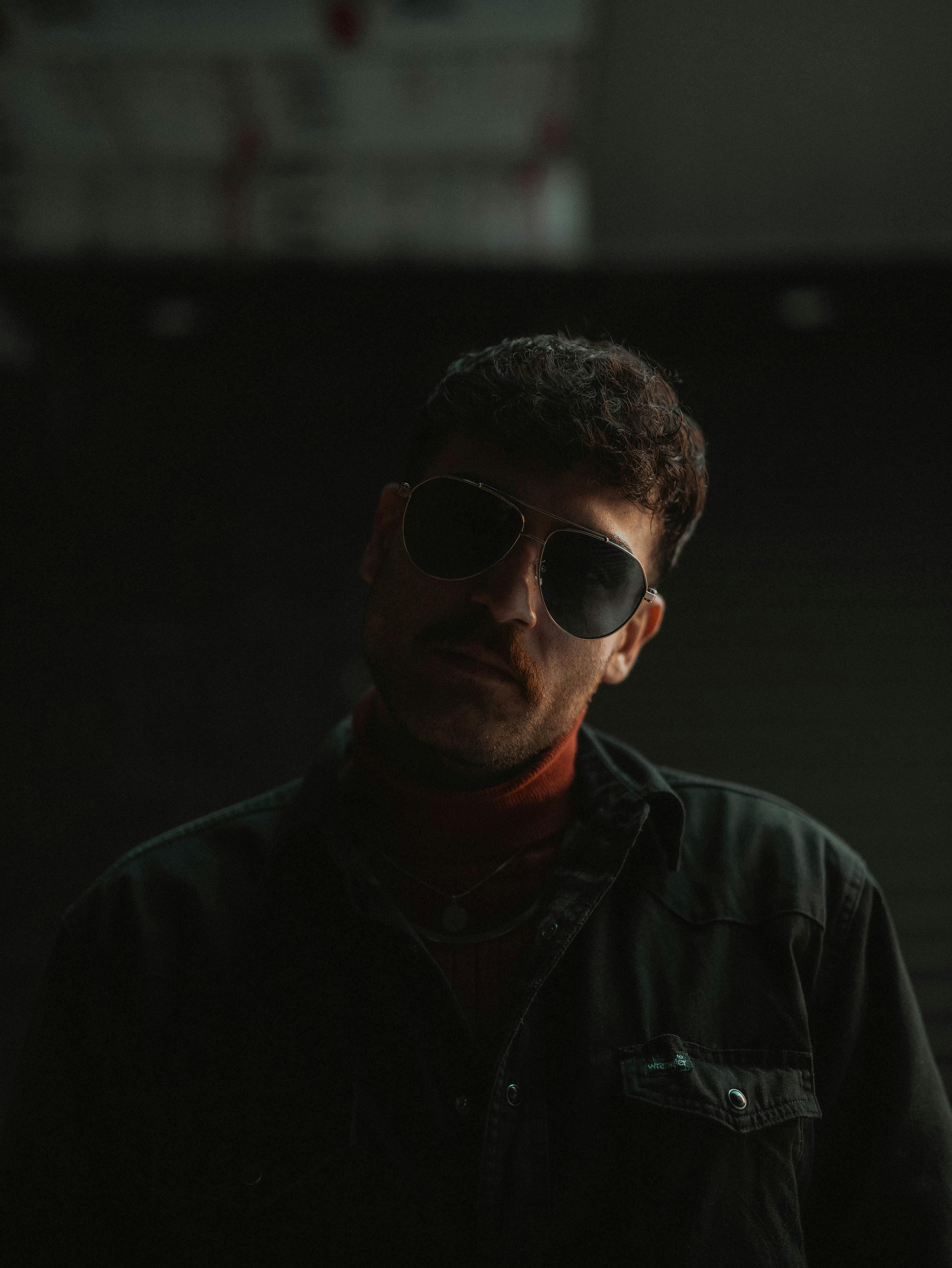 male silhouette, dark atmospheric background, green spectral rim lighting, partially obscured face, architectural studio lighting aesthetic