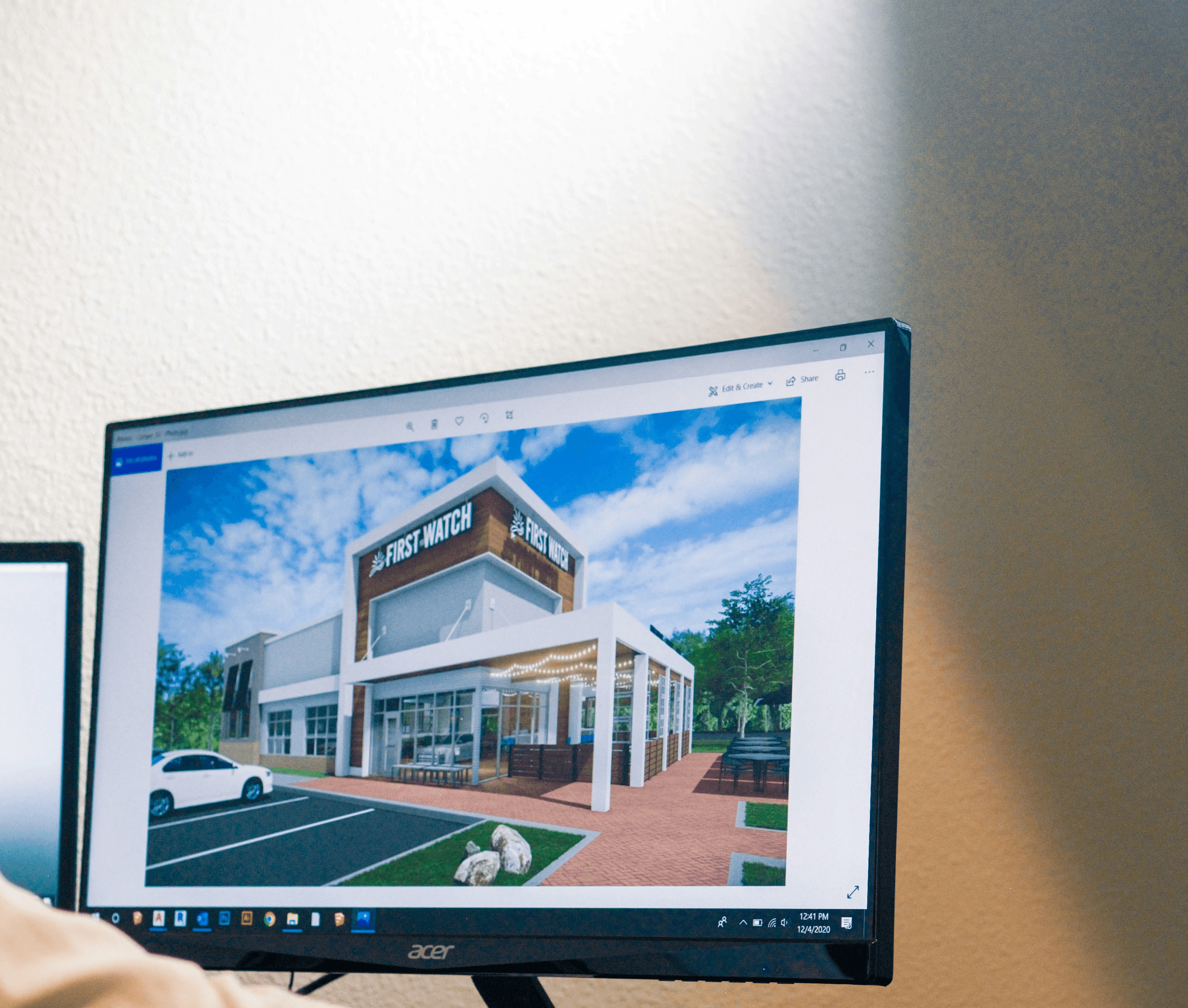a man sitting at a desk looking at a computer screen