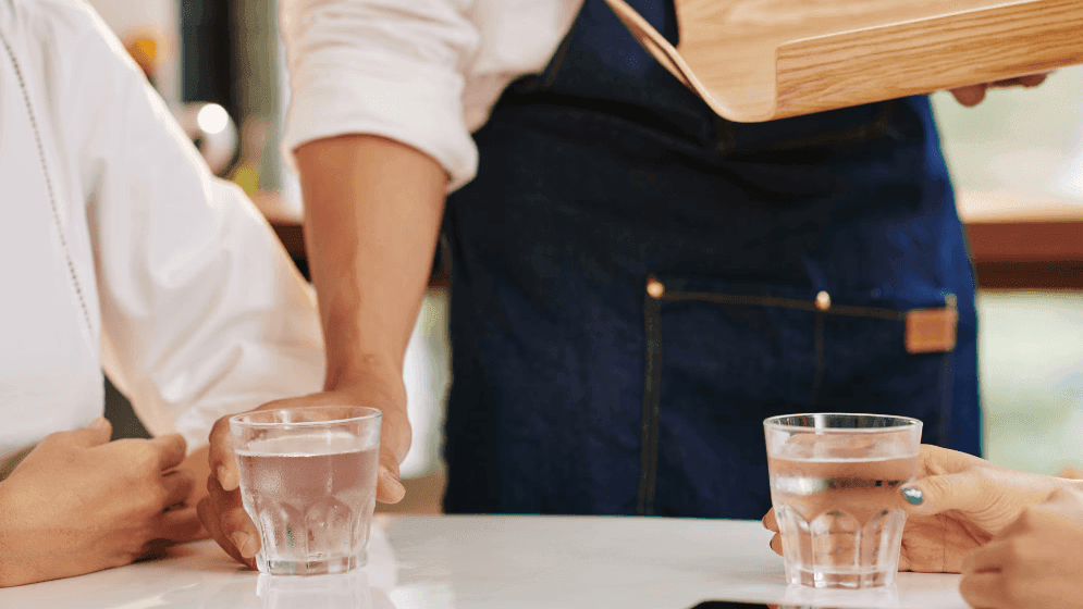 Waiter serving water