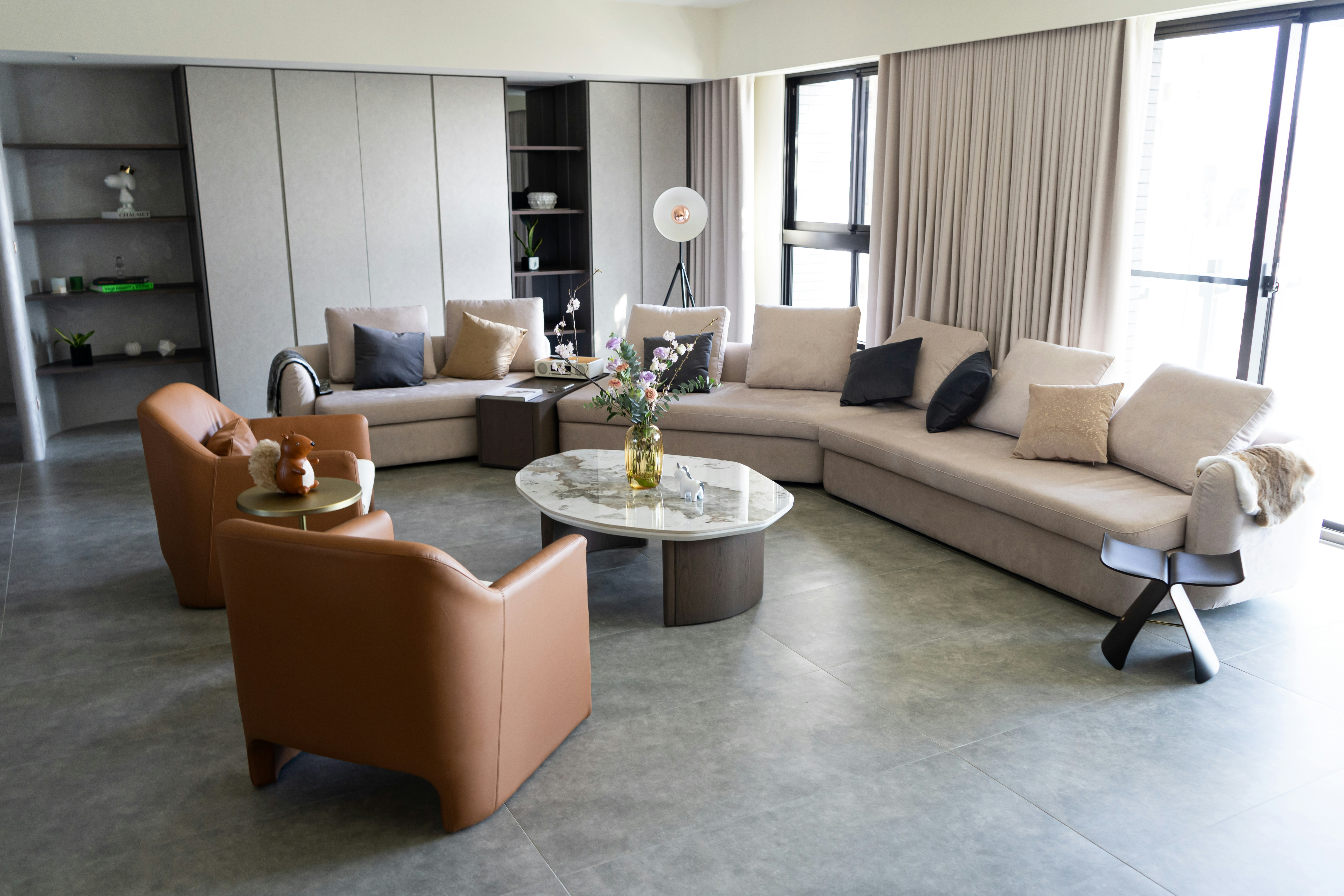 a living room filled with furniture and a large window