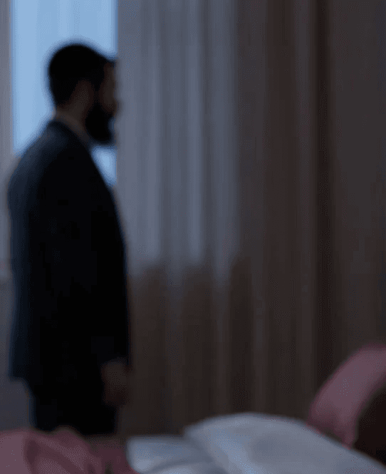 A woman receives a relaxing energy healing in a serene setting with soft lighting.