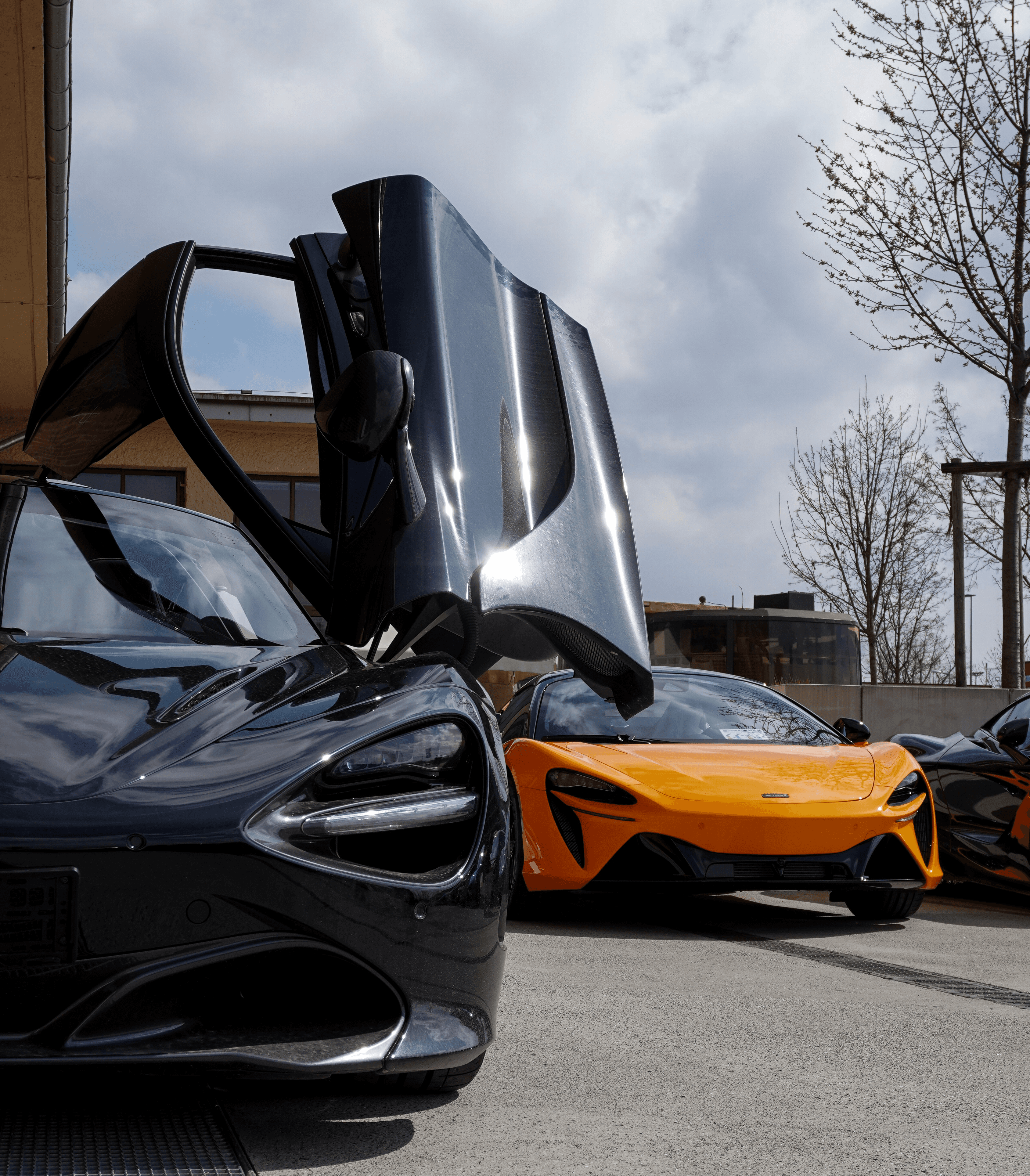 Several luxurious cars parked outdoors.