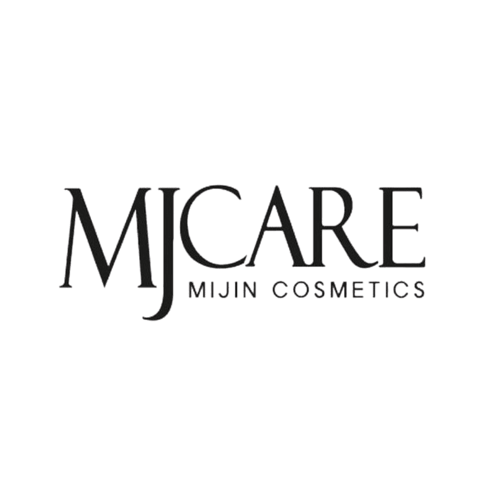 A young man with light brown hair is wearing a black suit jacket and white shirt, standing in a softly lit office setting, conveying professionalism.