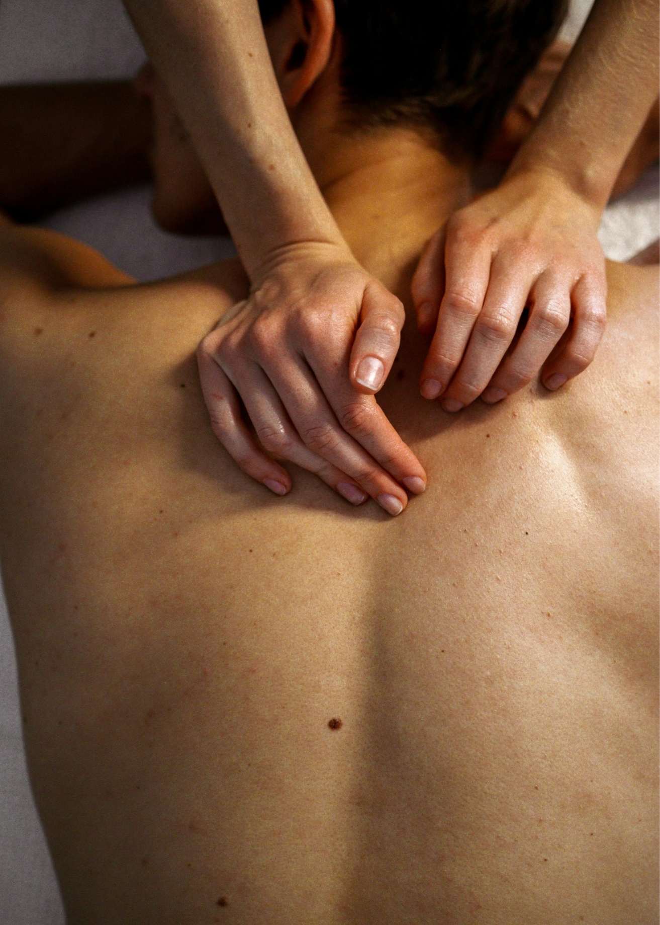 Close-up of hands performing bodywork massage, illustrating State of Soma’s therapeutic approach to holistic healing.