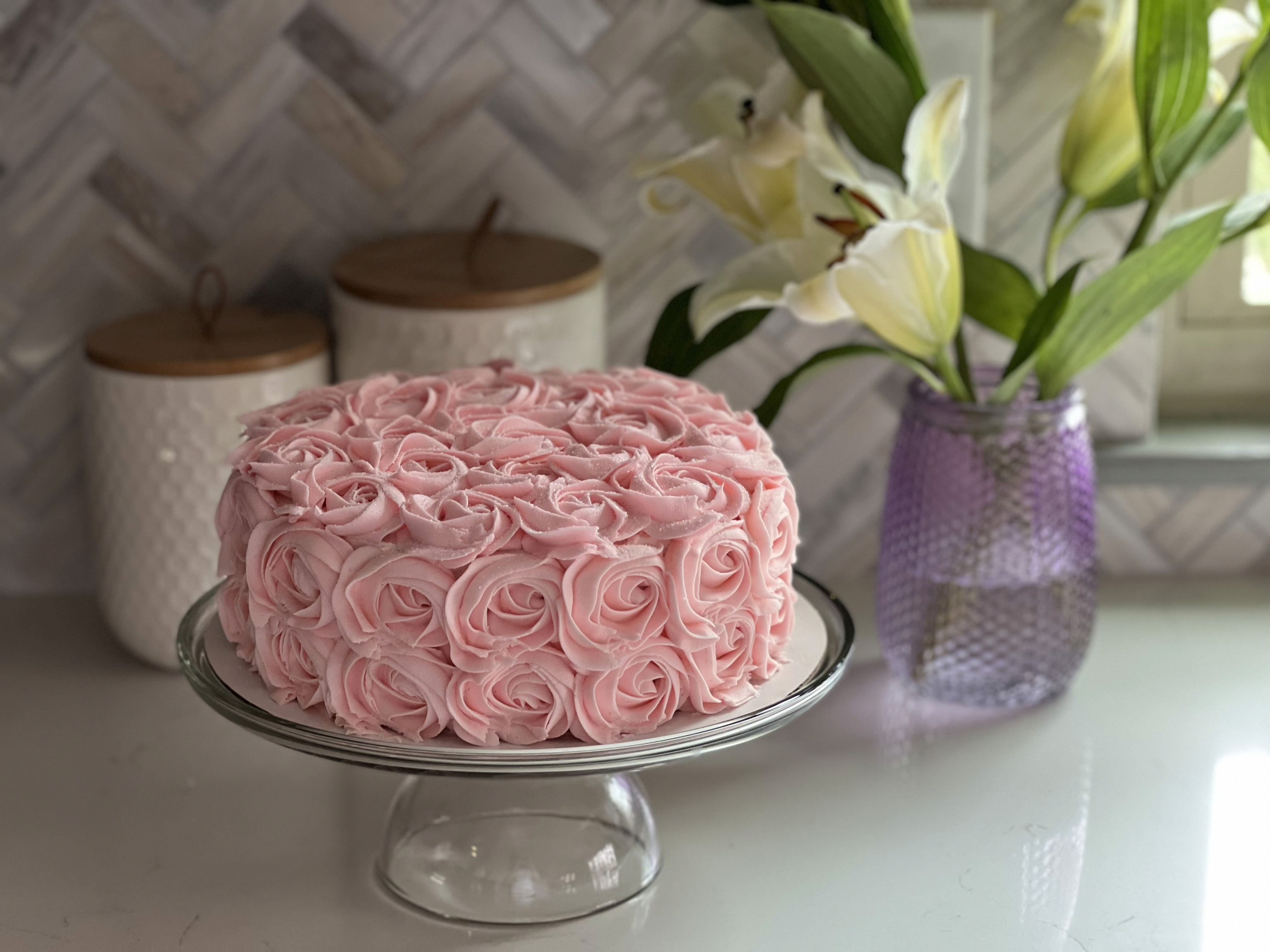 Pink rosette cake with white flowers