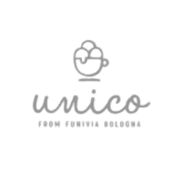 Smiling person with short dark hair in a black shirt against a plain grey background. The expression conveys warmth and friendliness.