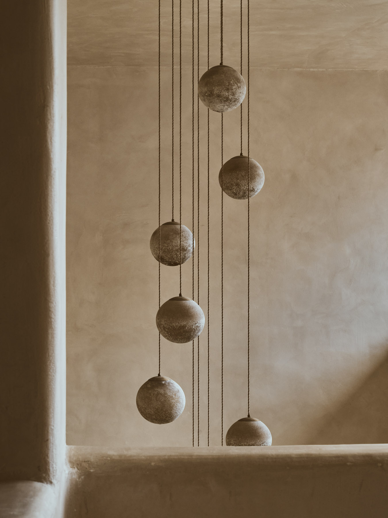 Pendant lamp detal in a concrete interior.