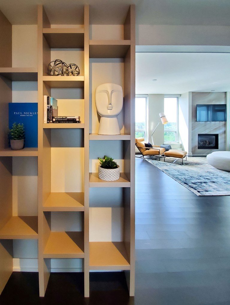 Image of Modern living room interior design with shelving unit, furniture, and KHD Homes design-build construction elements.