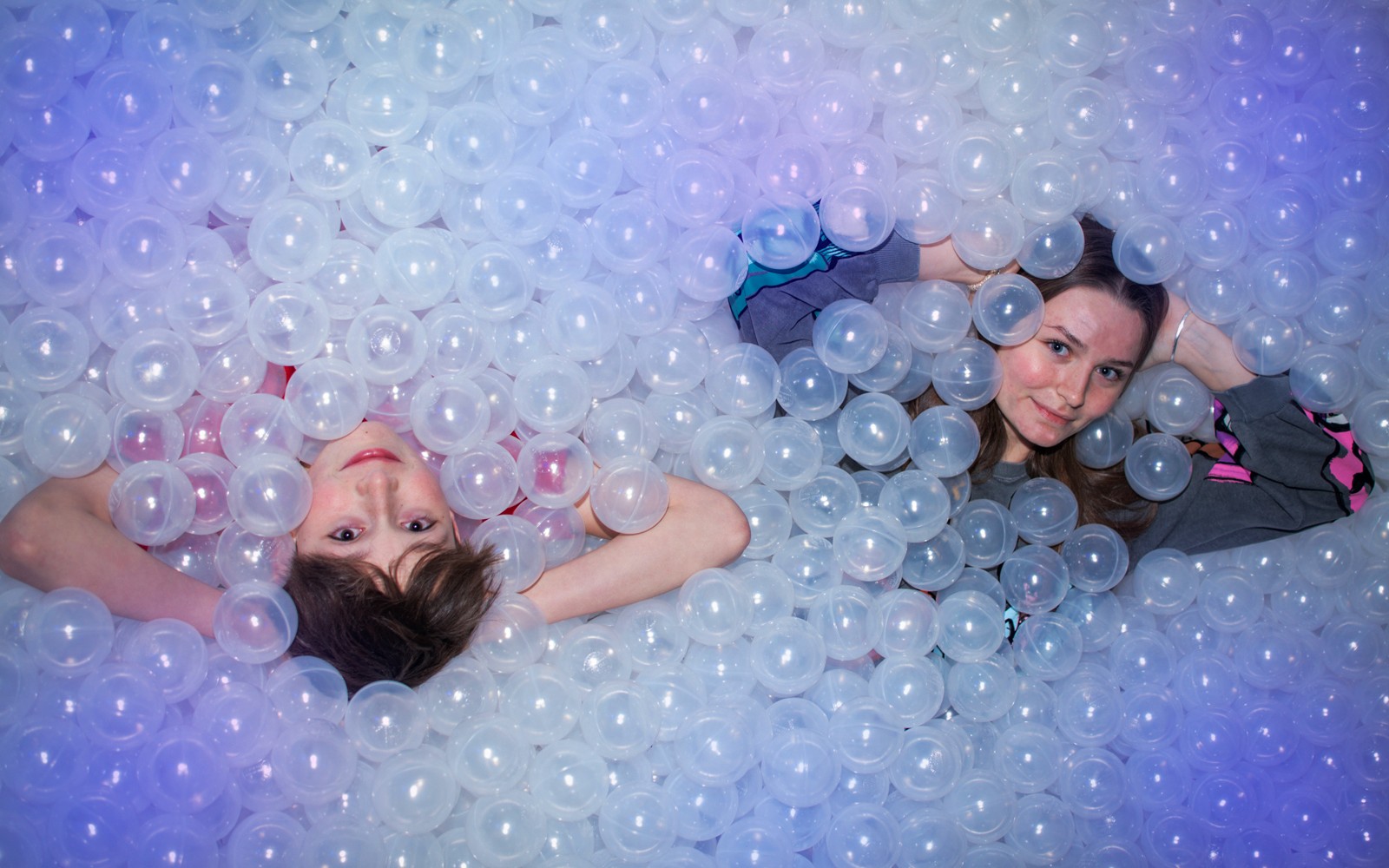 Emberek fekszenek egy labdatengerben a The TUBE látványosságnál.