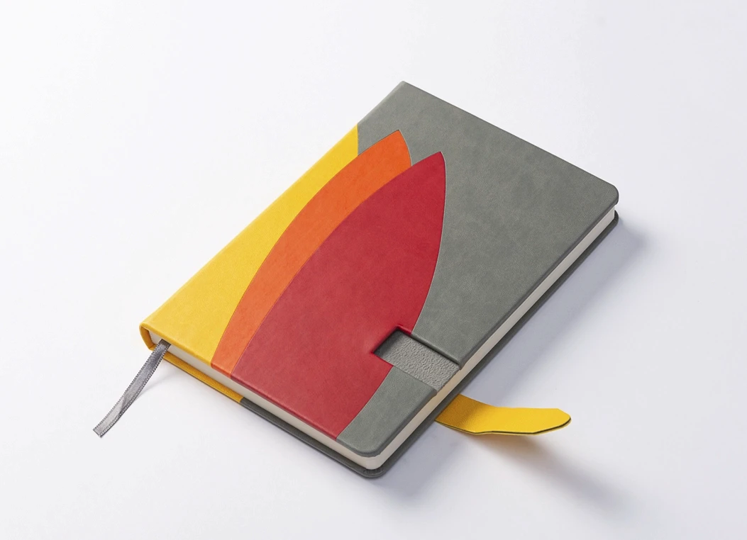 Color block leather journal with grey and yellow cover and strap closure