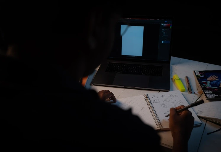 Team member working in moody light, capturing visual content focused on brand storytelling purpose