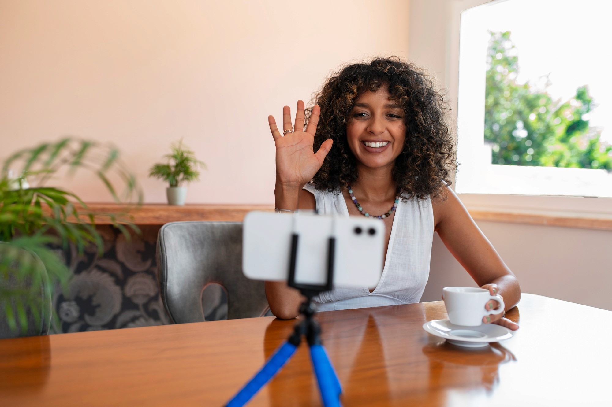 woman holding a phone and man looking at the phone. both are smiling