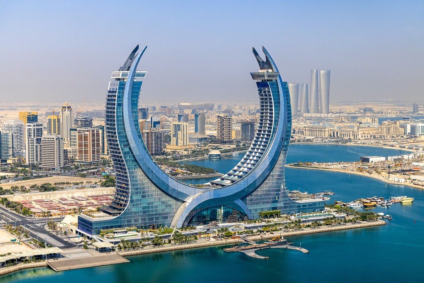 red train travelling near body of water