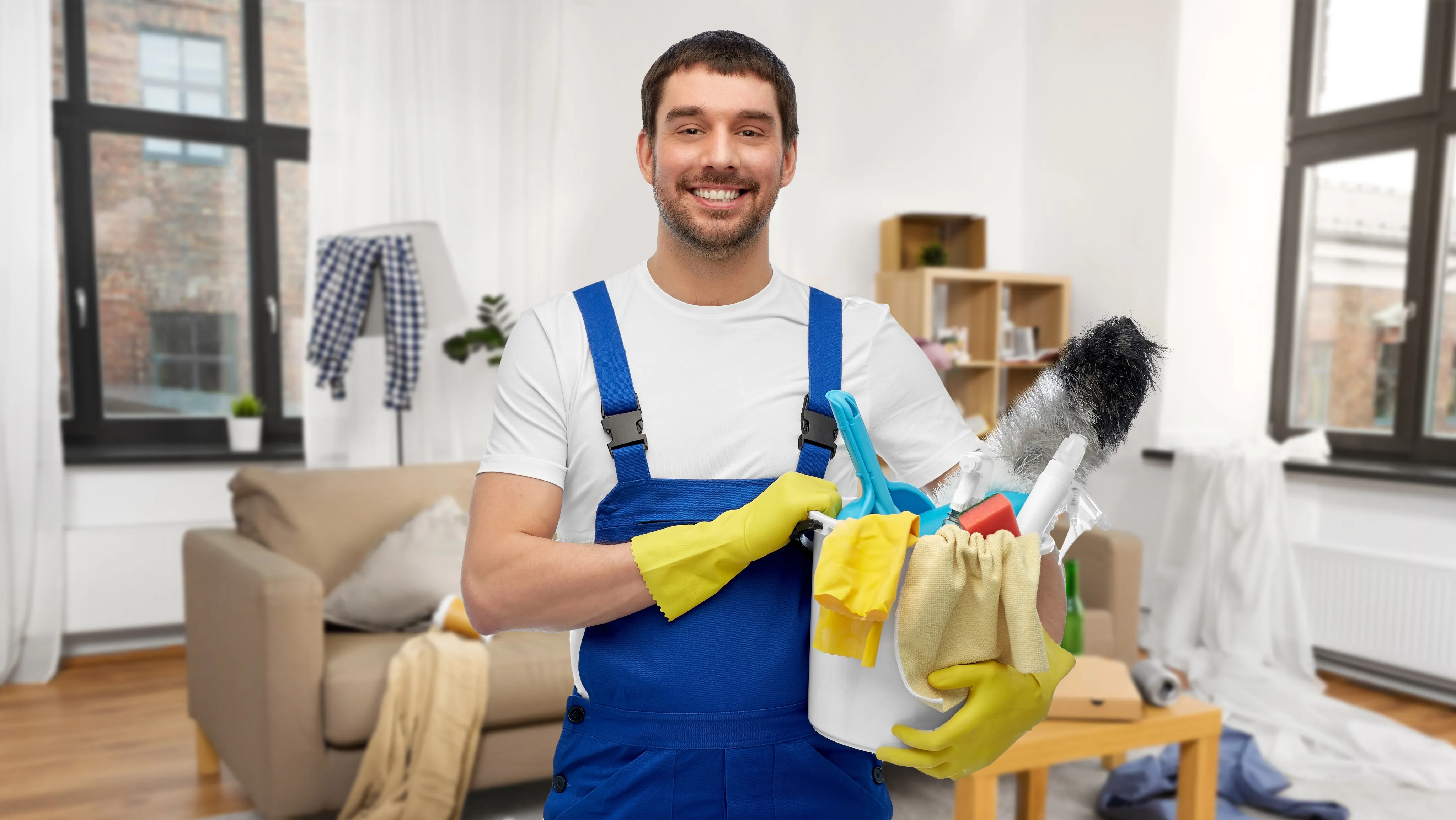 Professional portrait of Jackob Lee, a Junior Cleaner with 1 year of experience in commercial cleaning, wearing blue overalls and holding cleaning tools.