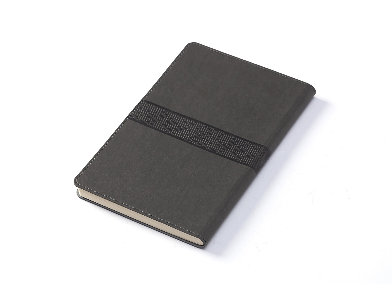 Angled view of closed grey notebook showing embossed texture detail.