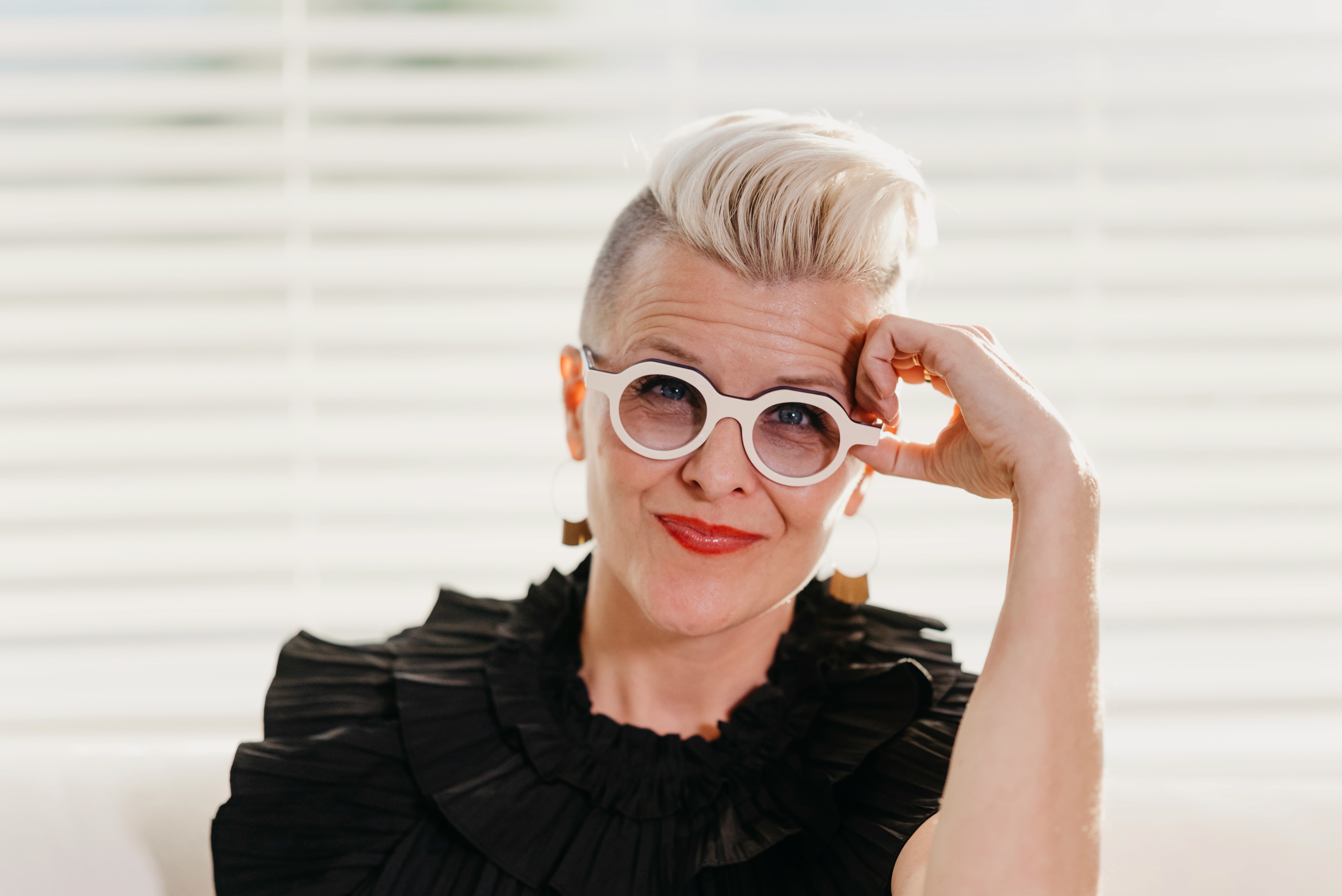A woman in a straw hat stands in the grass