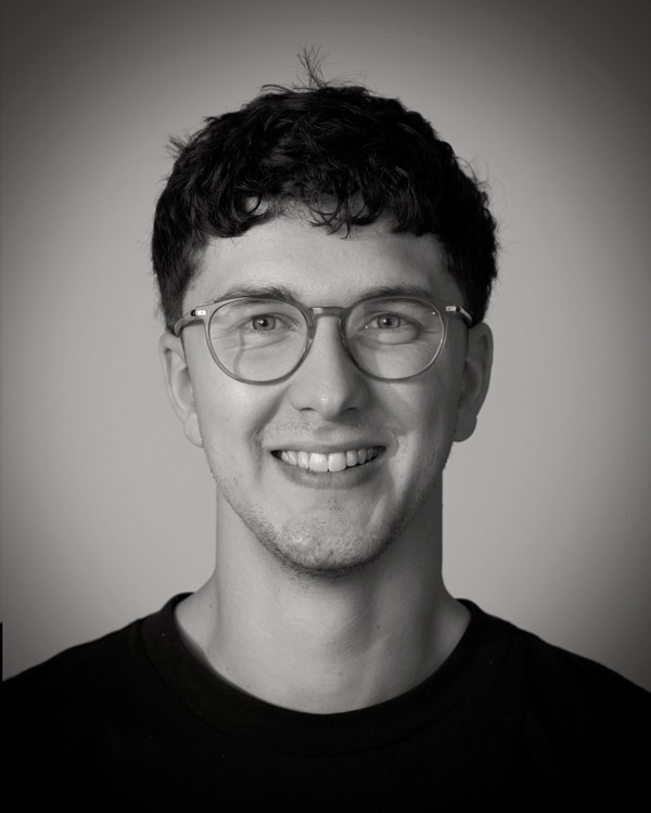 headshot of male in dark background