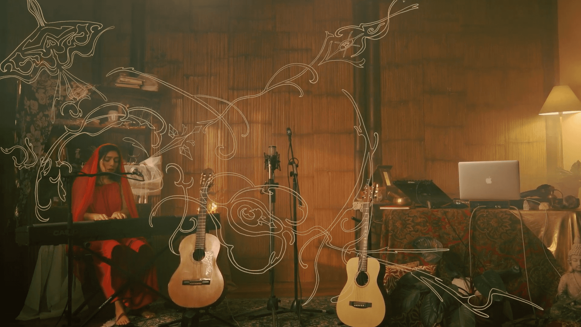 A close-up of a hand wearing multiple decorative rings against a blue background.