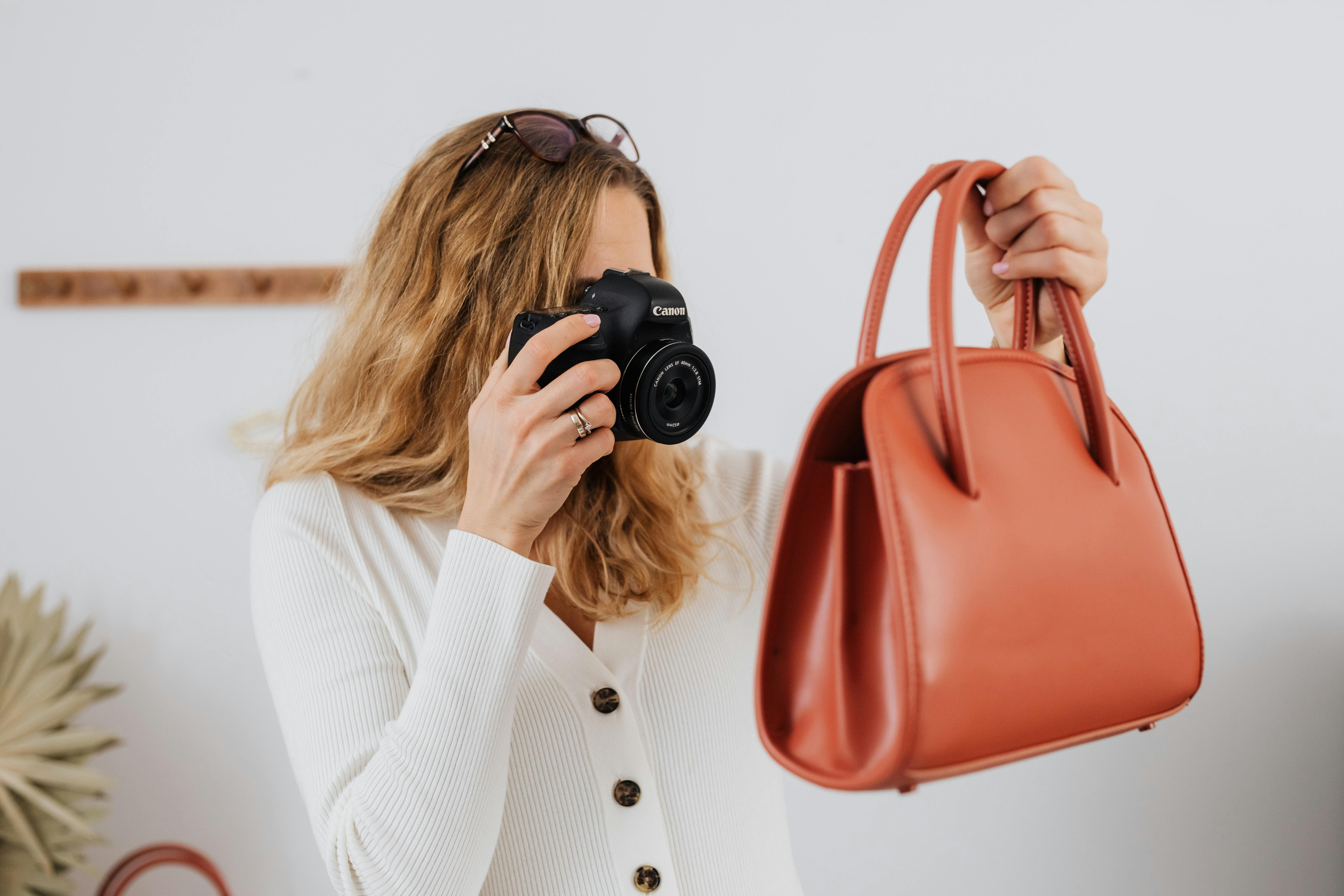 A woman doing Ecommerce Product Photography for a bag