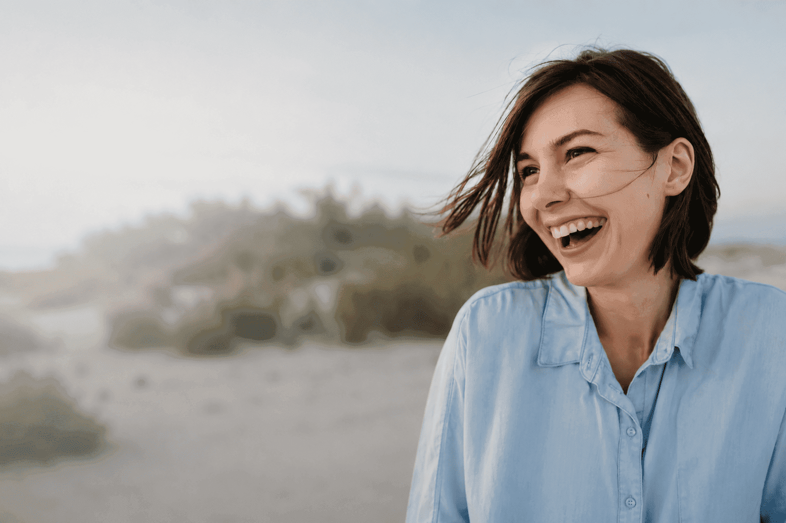 Smiling portrait candid of woman laughing