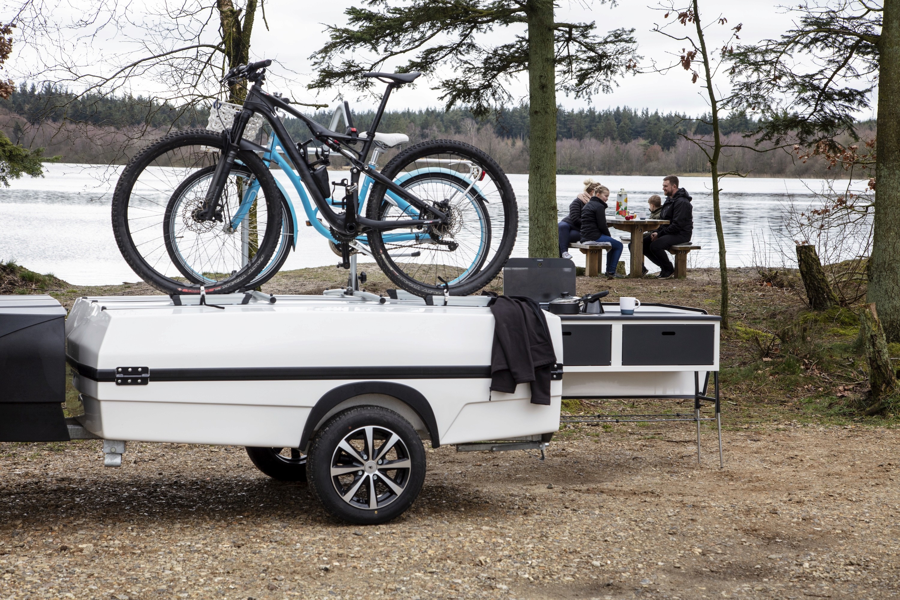 Camp-let stopped for a coffee with bikes on top.