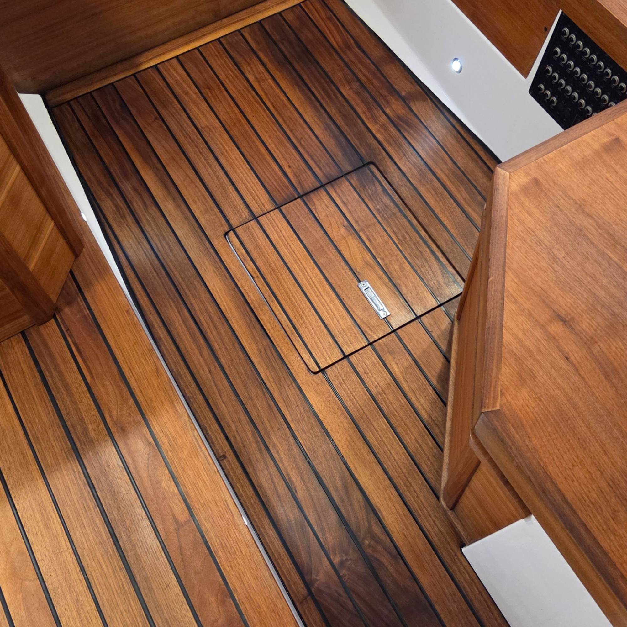 Teak flooring in a boat that is freshly restored and like new condition