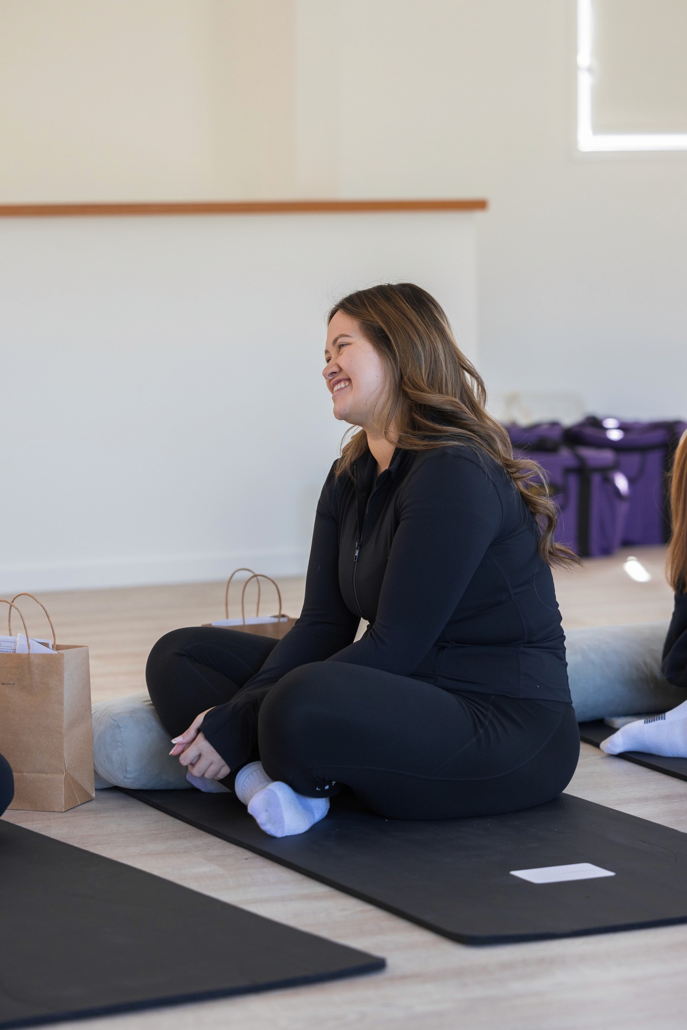 Woman sitting cross-legged smiling