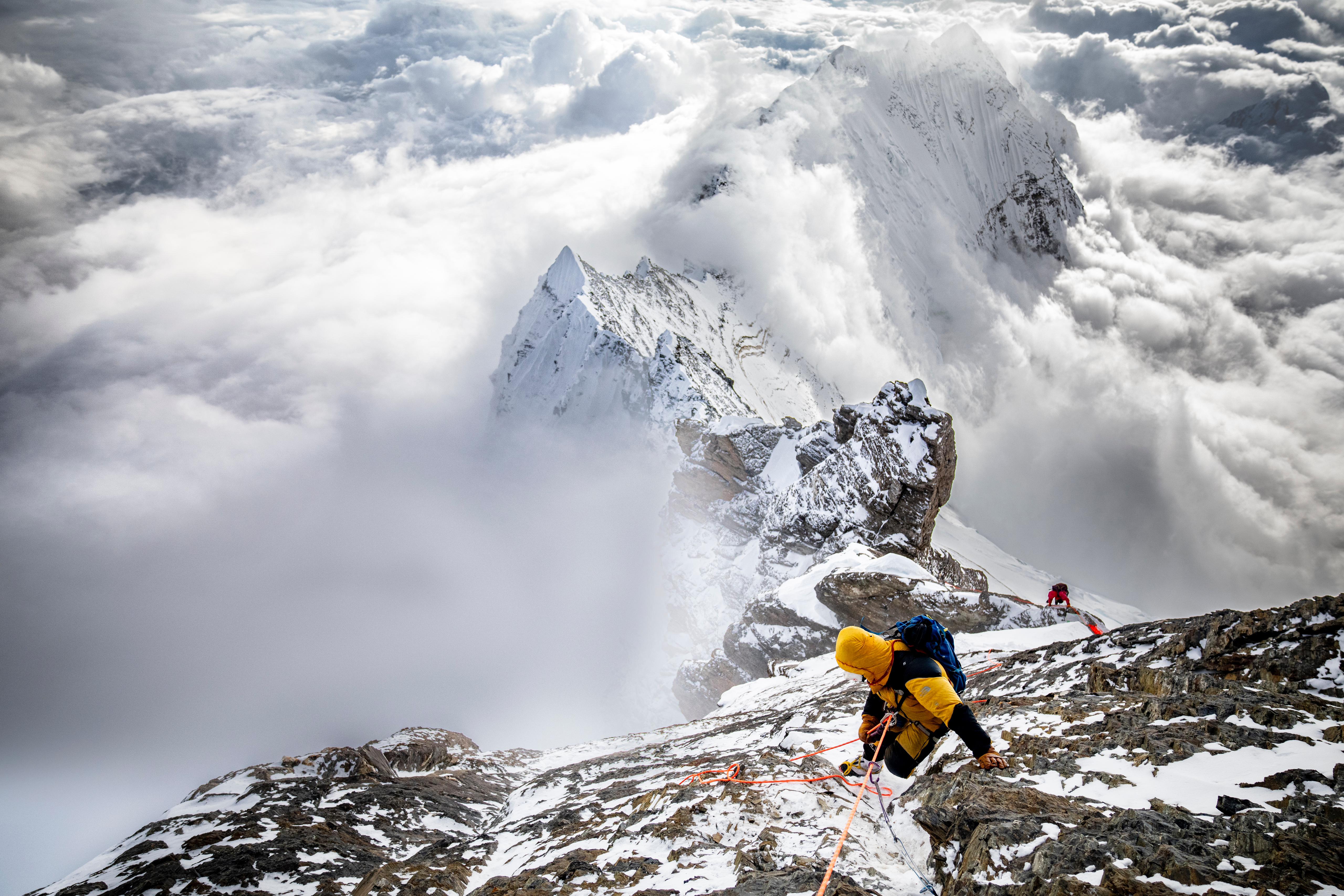 Two friends walking on the street and talking.