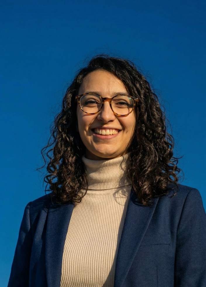 Woman in colorful striped sweater.